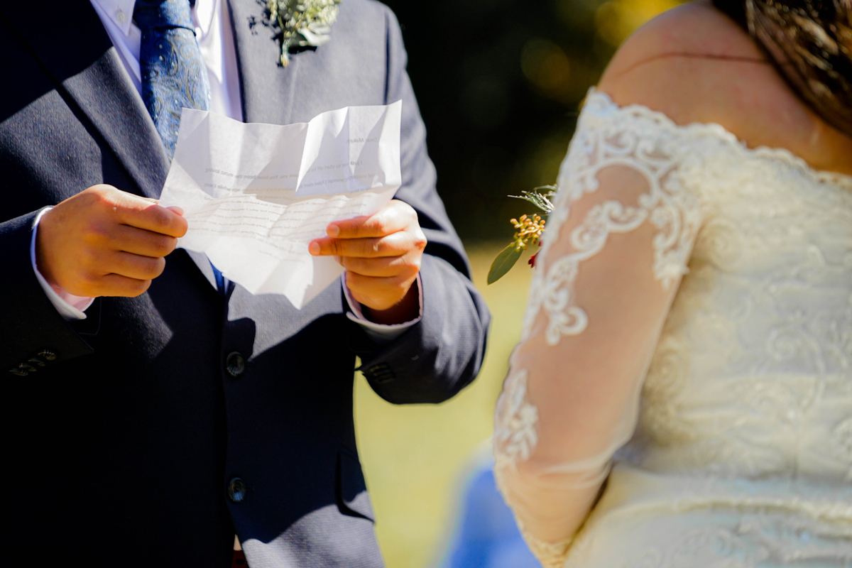 A groom reading his vows to his bride
